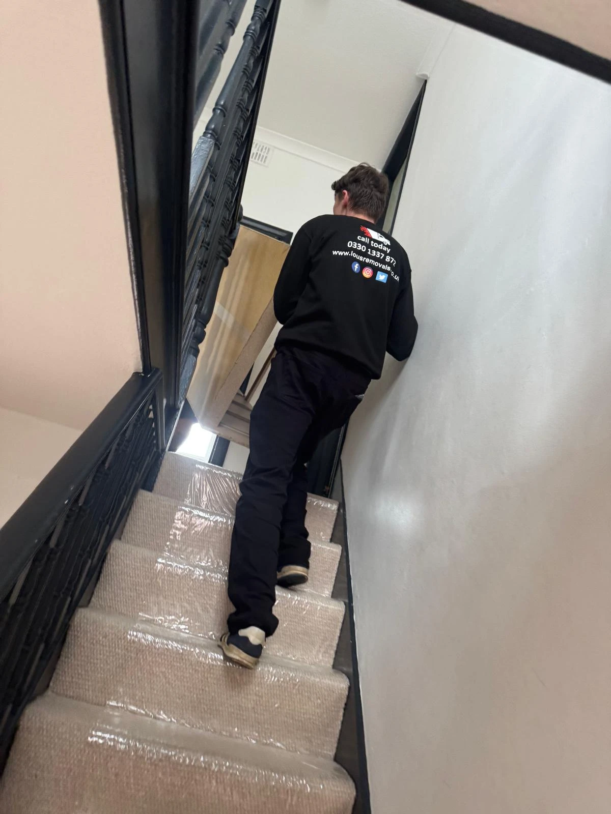 Man carrying furniture upstairs