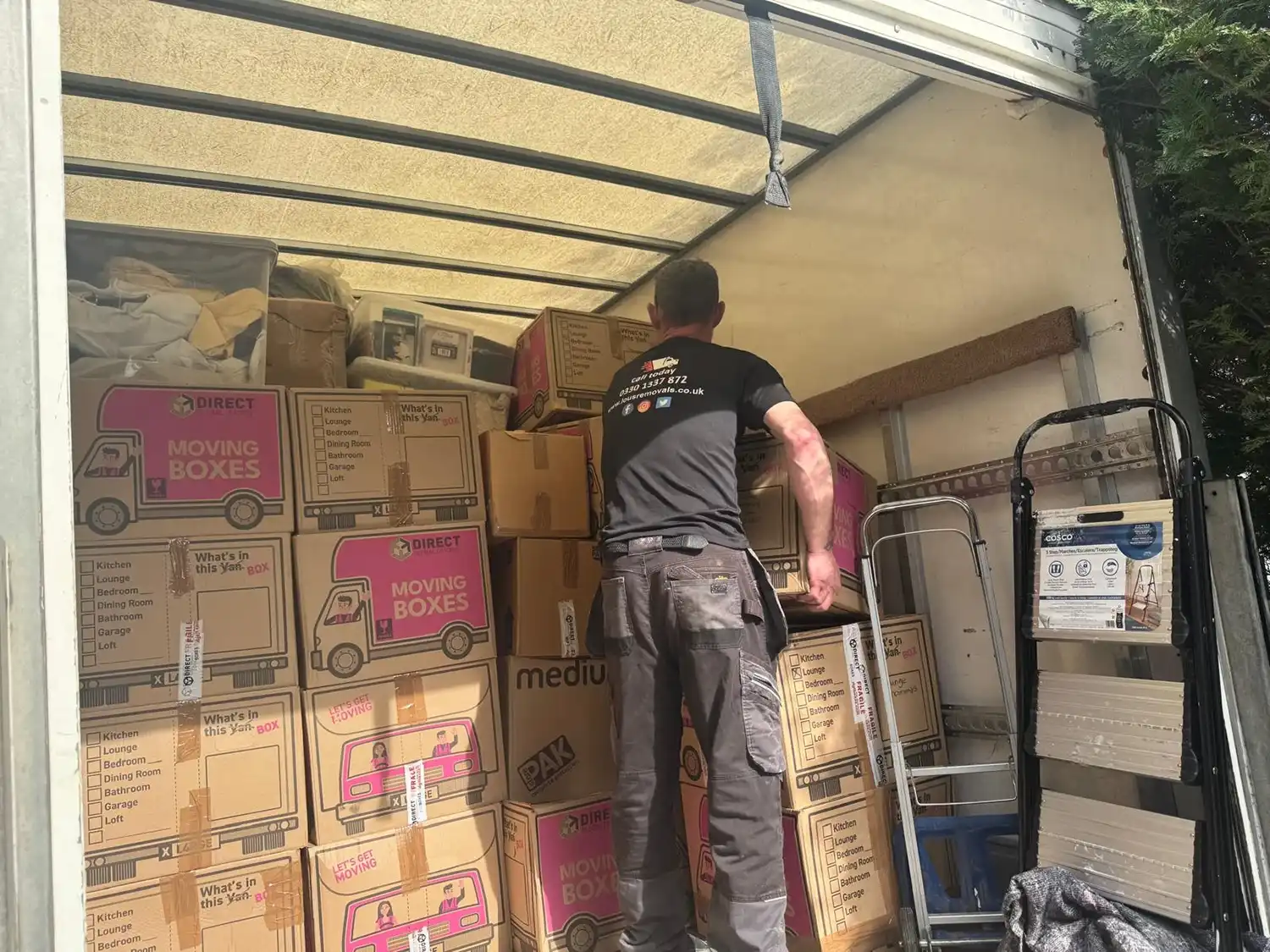 man packing boxes in the van