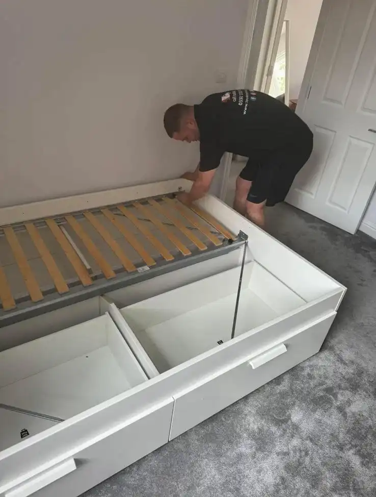 Man putting a bed together