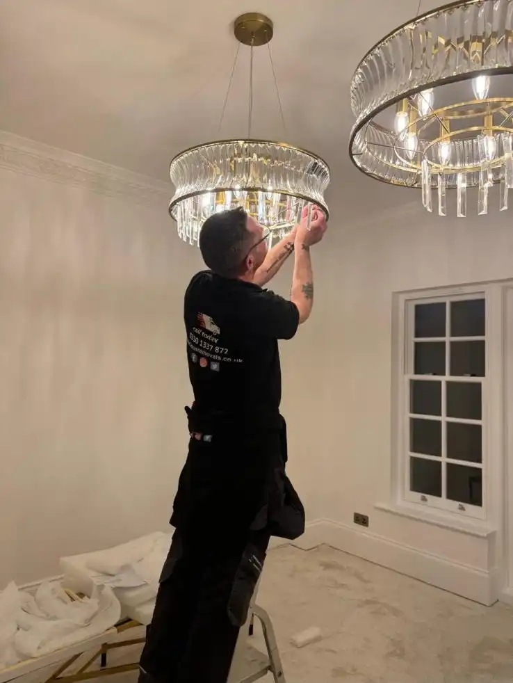 Man taking down a chandelier
