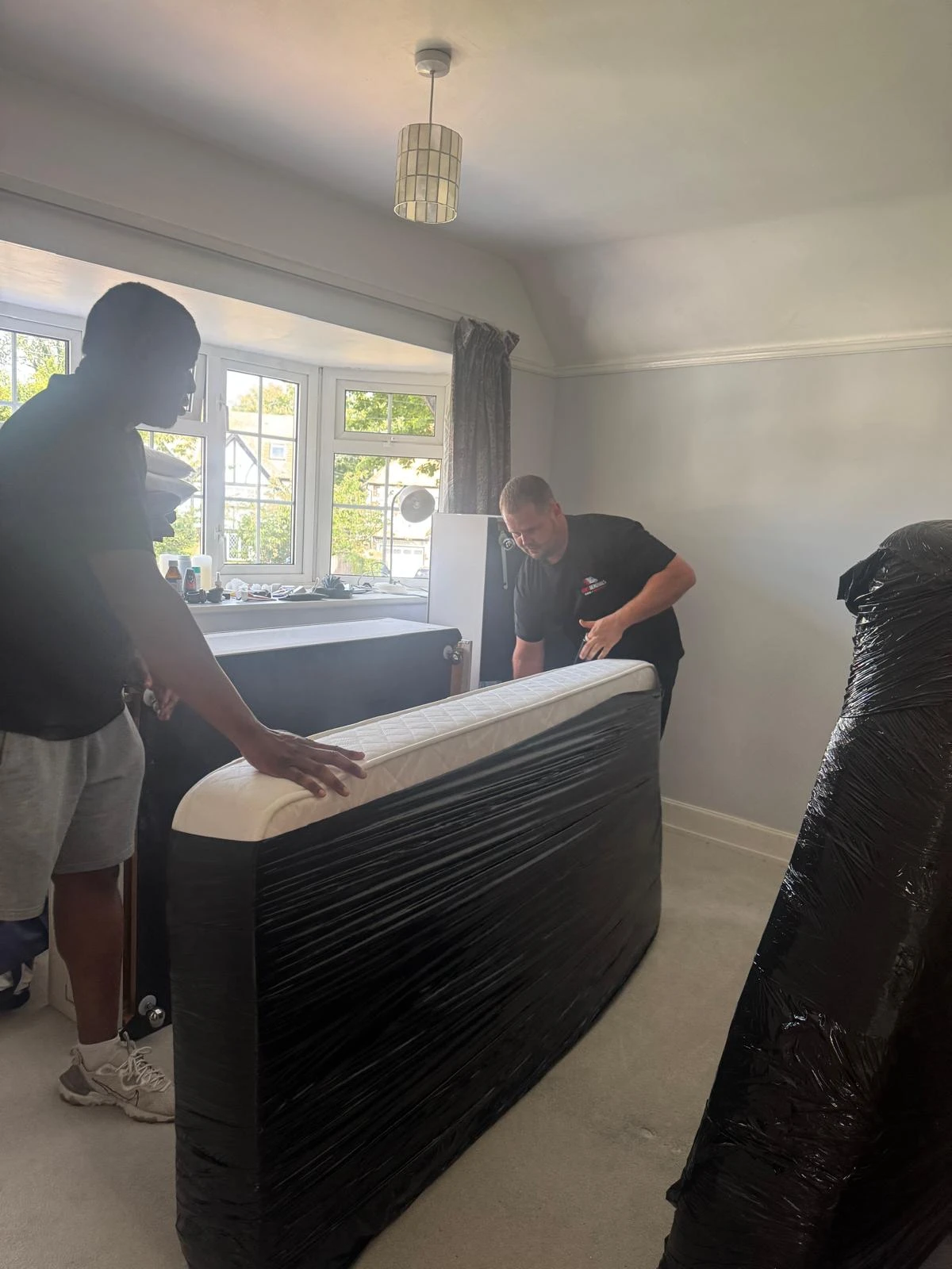 Men removing a kitchen unit.