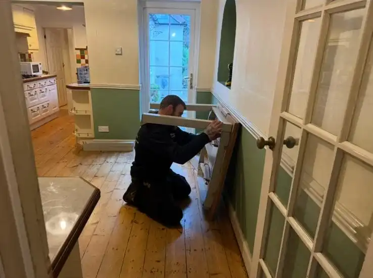 Man removing a bookscase.