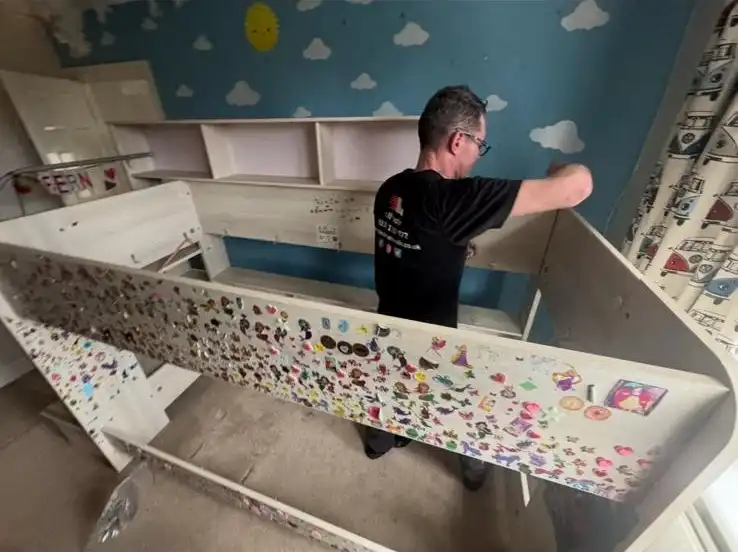Man building a childs bed.