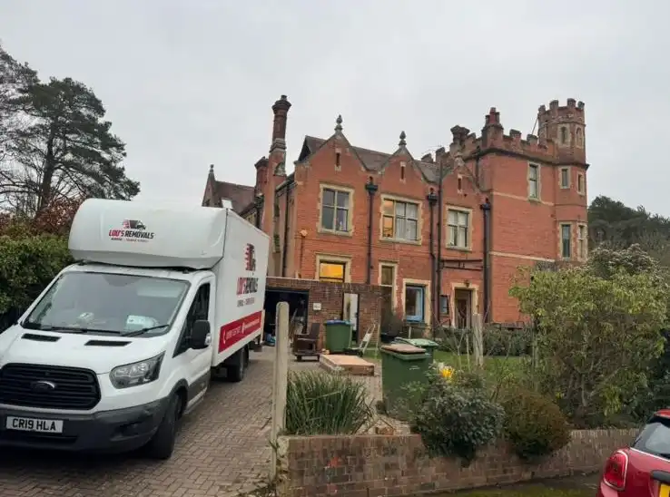 Van outside a large house.