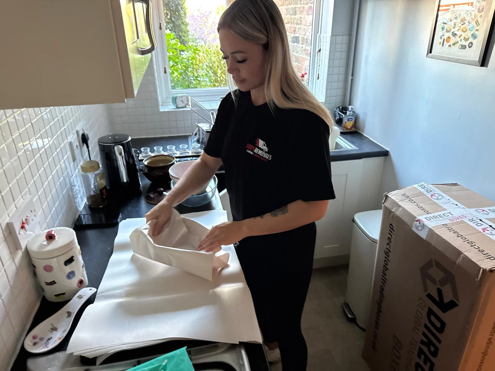Girl packing with paper.