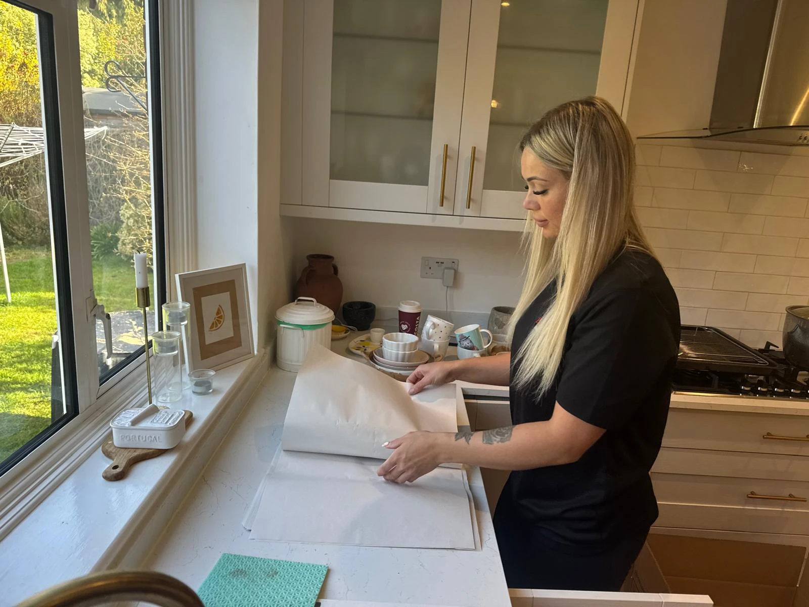 Girl packing items on the kitchen worktop.