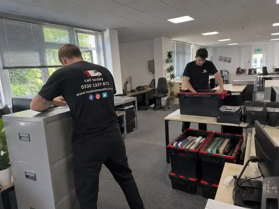 men moving office furniture